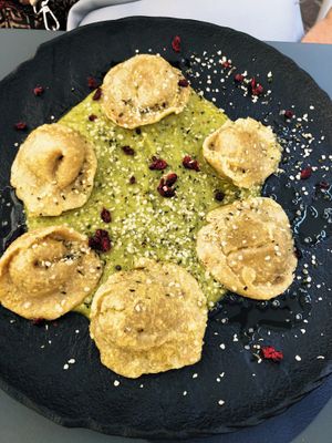 Tortelloni semi-integrali ripieni di vegRicottina di anacardo con erbette su crema di zucchine.  at Black Sheep Raw • Vegan Lab & Bistrot in Trento