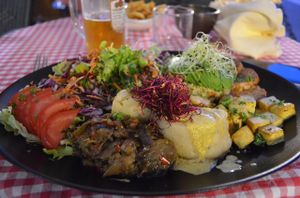 Today's "assiette veggie" (all organic!) was composed of mashed potatoes, tofu in an almond curry cream sauce, grilled tempeh with a tamari sauce, homemade eggplant purée, quinoa with vegetables, lettuce and crudités (tomato, carrots, cabbage), an avocado half and beet & fennel sprouts. Vinaigrette available on the side upon request. at La Salamandre in Etretat