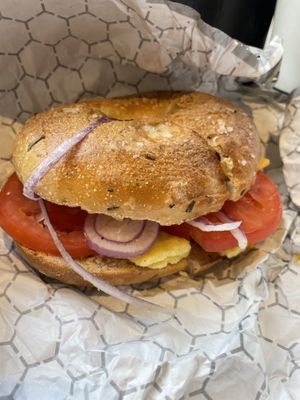 Rosemary salt bagel with tomato, onion, vegan egg, and vegan cheddarr  at Pavement Coffeehouse - Gainsborough St in Boston