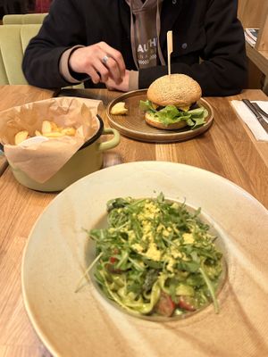 Seitan Beef Burger with Crispers Fries (furthest) and Tagliatelle with Garlic pesto and Asparagus (closest)  at Veganic in Krakow