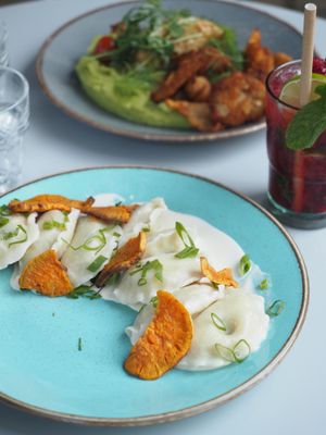 Vegan pierogi filled with tofu and mushrooms topped with sweet potatoes and vegan sour cream at Veganic in Krakow