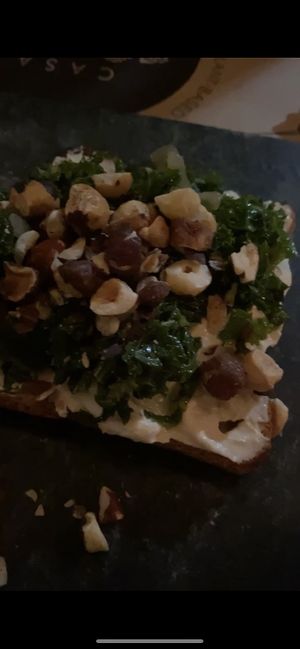 Bruschetta de creme de castanha, couve refogada e avelãs  at Casa Raw in Sao Paulo