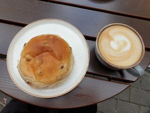 Bun with raisins and an oat latte at Godt Brød in Oslo