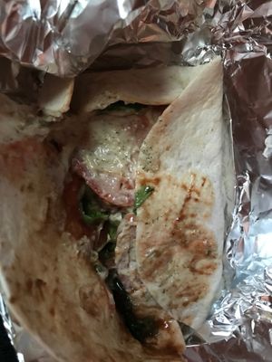 Inside the Vegan TomTom Wrap, with seitan, homemade peanut butter, and tartar spread, with pickles, lettuce, tomato and vegan cheese. at Mayka in Belgrade