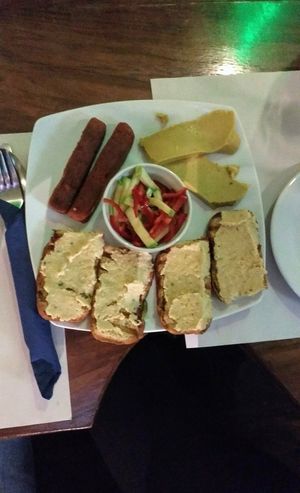 Mayka platter: Seitan sausages, soft vegan cheese, bread with spreads at Mayka in Belgrade