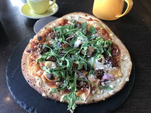 Vegan pizza with Mushrooms,Rocket,Red onion ,Chilli oil,Tomatoes ,Veggie haggis & Vegan cheese
  at Cafe Sia in Isle Of Skye