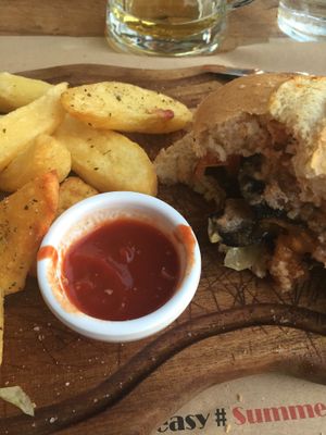 portobello mushroom burger with fries at Nice n Easy in Mykonos