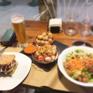 Salad, mojo potatoes, burger club sandwich at Bioloco in Gran Canaria