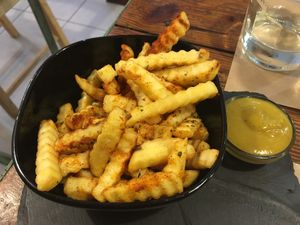 Spicy crinkle fries with mustard dip at Bioloco in Gran Canaria