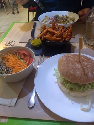 BBQ burger with side salad. Energy salad (large) in the distance with sweet potato fries and mustard at Bioloco in Gran Canaria