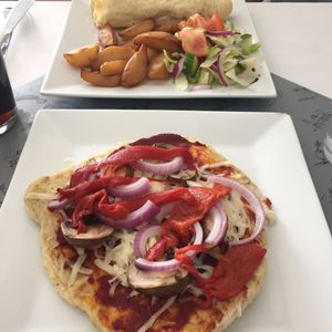 Vegan pizza and sausage roll with chips at Veggie Rae in Bury