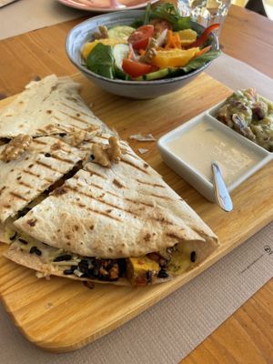 Vegan quesadilla, accompanied by a salad, guac and vegan “sour cream”  at Earth Shop and Cafe in Carvoeiro