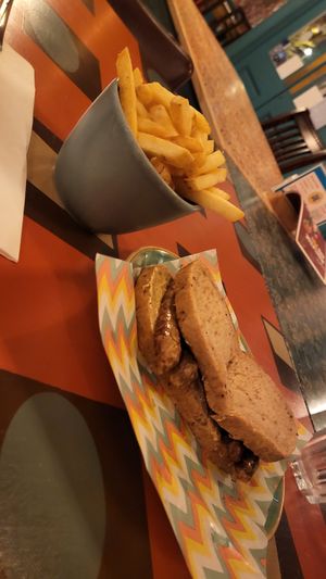 Vegan Sausage Butty and Chips at Quinto Lounge in Sutton Coldfield