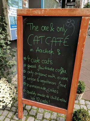 Sidewalk sign in front of cafe. at Milou in Aachen