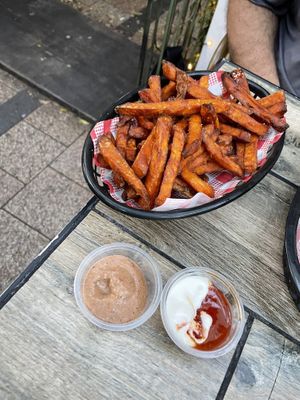Sweet potato fries with vegan chipotle aioli, and vegan sour cream with I think sweet chili sauce   at The Hold in Manly