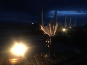 Table in the sand with candles  at Mowie's  in 