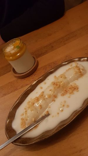 Desserts: Mango in sticky rice with coconut sauce and peanut sprinkles. Rear: Another mango and coconut dessert, also delicious. at Hum Vegan Cuisine in Berlin