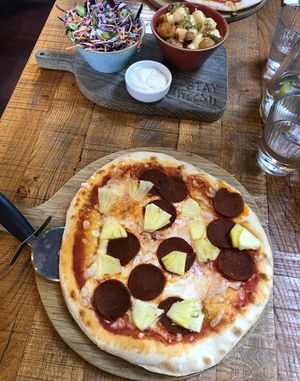 Pepperoni pizza with pineapple, tater tots and coleslaw.  at The Stable in Bath