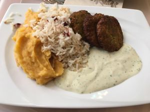 rice, sweet potato mash, broccoli patties and a basil vegan creamy sauce at Great Bistro in Budapest