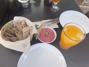Bread and beet houmous, fresh orange juice at Alfarroba Cafe in Albufeira