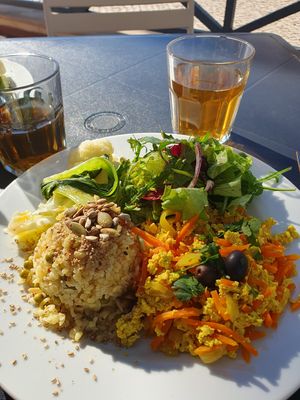 Tofu scramble,  grains, veggies,  salad with chilli sauce at Alfarroba Cafe in Albufeira