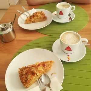 Apple-almond pies and coffee with soy milk at Alfarroba Cafe in Albufeira
