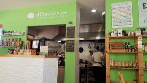 Kitchen and counter area with small organic shop at Alfarroba Cafe in Albufeira