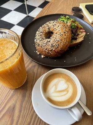 Vegan bagel with hummus and beetroot, fresh orange juice, cappuccino   at Kawiarnia Stragan in Poznan
