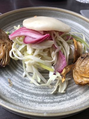 Bao bun with white cabbage , pickles red onion and grilled artichokes at Restaurang Sand in Bastad