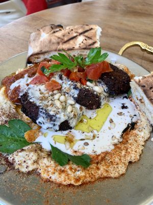 Tahini sauce on top of hummus and falafel   at Mezze Bar in Auckland