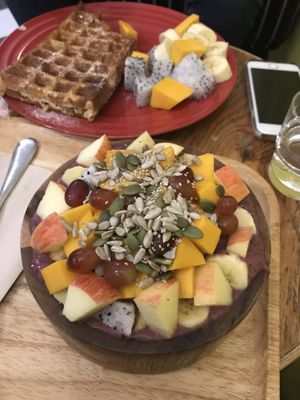 Waffle with seasonal fruits in the back and smoothie bowls in the front, both really delicious! at Coco&Co in Vientiane