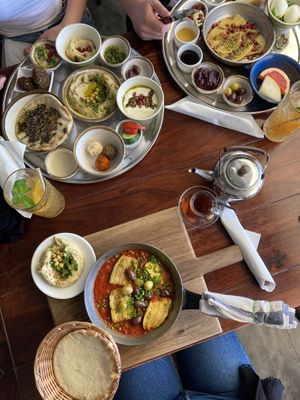 Lebanese breakfast (top left), Moroccan breakfast (top right), vegan shakshuka with zucchini and olives (bottom) at Shuk in Warsaw