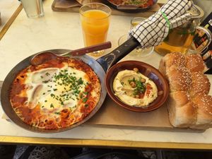 Shakshuka served with hummus at Shuk in Warsaw