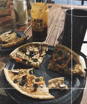 Pizza and fries  at Akarma Vegan in Mexico City