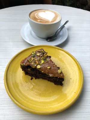 Torta de arequipe y chocolate y capuchino en leche de coco. at Cardamomo in Bogota
