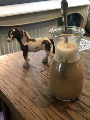 The horse table and a chai latte oat. at Hommage in Cologne