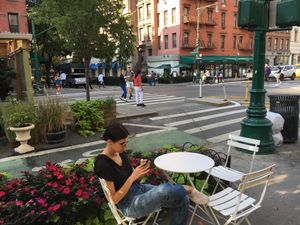 Outdoor seating consists of one table and three chairs. at Juice Press - Columbus Ave in New York City