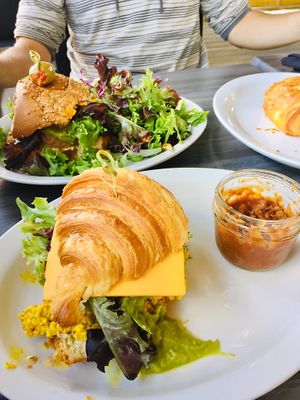 Delicious messy vegan breakfast croissant with tofu scrambled, beyond burger and chocolatine!  at Restaurant L'Odika in Drummondville