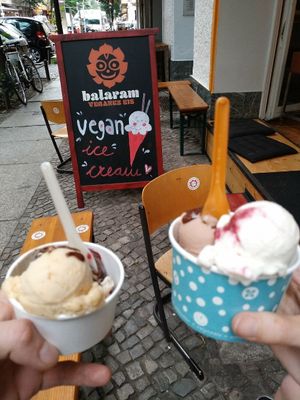 Small cups, one  with nougat, peanut and cheese cake and apple sauce cinnamon, chocolate and starberry topping sauce! at Balaram Eis in Berlin