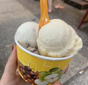 Peanut crunch and blueberry cheesecake. Underneath is pistachio.  at Balaram Eis in Berlin