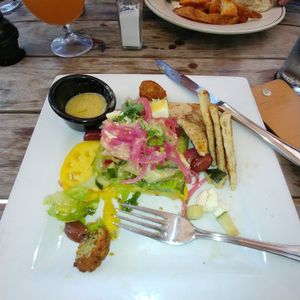 Half eaten green salad with chickpea fritters at McCoy's Public House in Kansas City