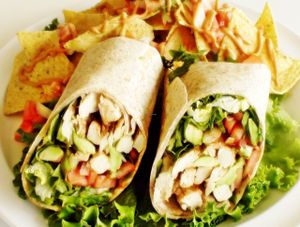 Loving Hut Wrap - Vegan non-GMO  tender seitan strips, crispy salad greens, sweet onion, pickles, avocado, juicy tomato, and homemade BBQ sauce, all wrapped in a whole wheat tortilla. at Loving Hut in Litchfield Park