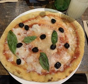 Pizza Margarita with olives and basil  at Zizzi - Tower Hill in London