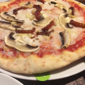 the classic pizza with mushrooms, tomatoes and garlic, the little sticker is the vegan sticker  at Zizzi - King St in Manchester