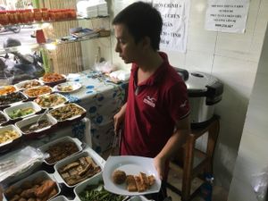 Cafeteria style menu at A Di Da Phat in Ho Chi Minh City