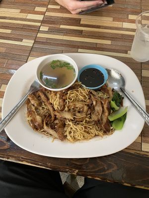 Vegan duck with yellow noodles. The two sauces are a spicy soy and a mildly spicy stock.  at Jai Mai Jumjay in Chiang Mai