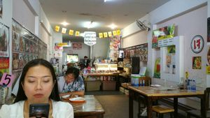 The wife is always on her phone at Jai Mai Jumjay in Chiang Mai