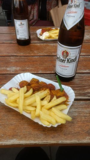 Vegan currywurst and chips (in the background meat currywurst and chips)  at Curry at the Wall - Food Stand in Berlin