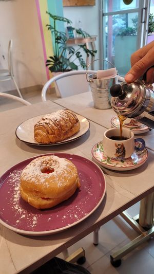 filled donut with whipped cream and jam & Coffee at Frambuesa Pastelería Vegan in Bogota