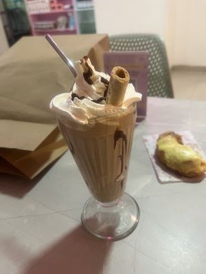 Vegan chocolate milkshake! And half a doughnut, because why wait 🙋🏻‍♀️  at Frambuesa Pastelería Vegan in Bogota